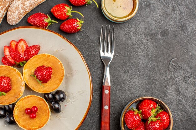 Draufsicht leckere Pfannkuchen mit Früchten auf Dunkelheit