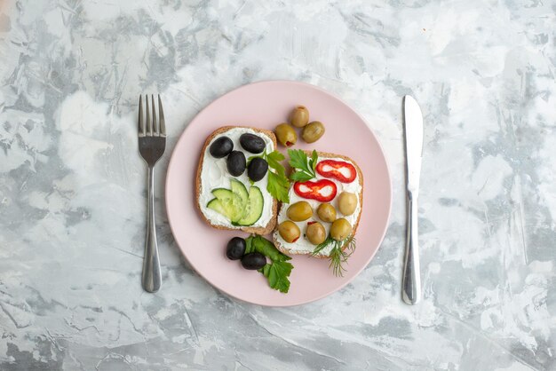 Draufsicht leckere Sandwiches mit Gurken und Oliven im Teller weißer Hintergrund Brot Essen Mittagessen Burger Essen Gesundheit Toast Frühstück