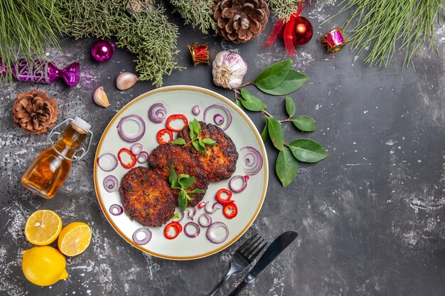 Draufsicht leckere Schnitzel mit Zwiebelringen auf dem grauen Hintergrundgericht Mahlzeit Foto Fleisch