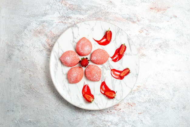 Draufsicht rosa Erdbeerkuchen kleine Süßigkeiten auf weißem Hintergrundkuchen-Keks-Tee-Fruchtkeks-süßem Zucker