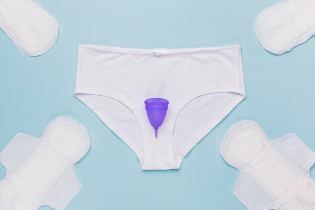 Draufsicht Schlüpfer mit Menstruationstasse und Damenbinden