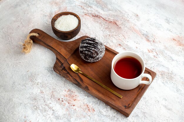 Draufsicht Schokoladenkuchen mit Tasse Tee auf weißem Hintergrund Schokoladenkuchen Kekszucker süße Kekse