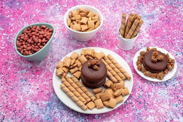 Draufsicht Schokoladenkuchen zusammen mit Keksen Erdnüsse auf der farbigen Hintergrundkekskeks süße Snackfarbe