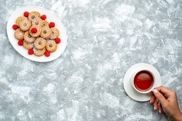 Draufsicht süße Kekse mit Himbeer-Konfekt in der Platte auf weißem Hintergrund-Kekszucker-Keks-Kuchen-Tee süß