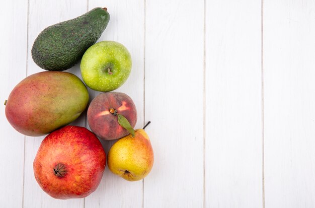 Draufsicht von frischen Früchten wie Mango-Birnen-Apfel-Granatapfel auf Weiß mit Kopienraum