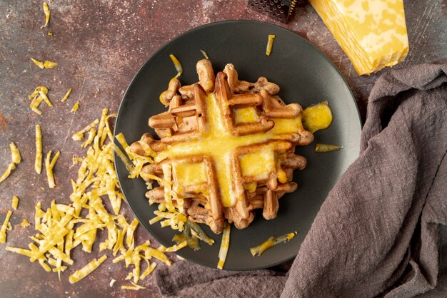 Draufsicht von Waffeln auf Platte mit geschmolzenem Käse