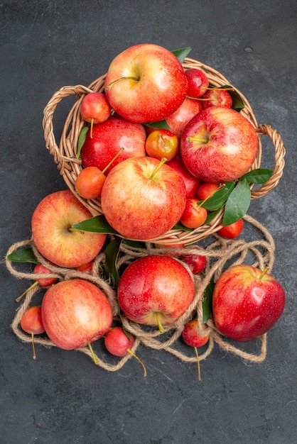 Draufsicht von weitem Äpfel Seil die appetitlichen Äpfel rot-gelben Kirschen im Korb