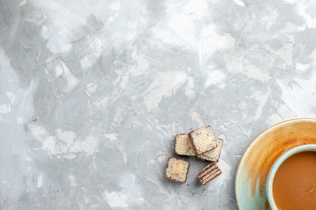 Draufsicht Waffeln und Kaffee auf dem hellweißen Hintergrund trinken süße Zuckerfarbe