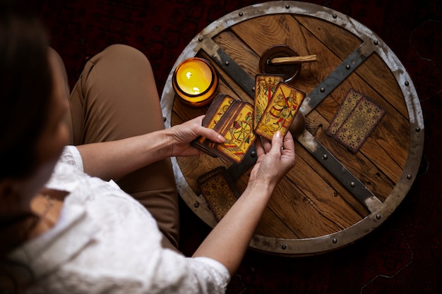 Kostenloses Foto draufsichtfrau, die tarot liest