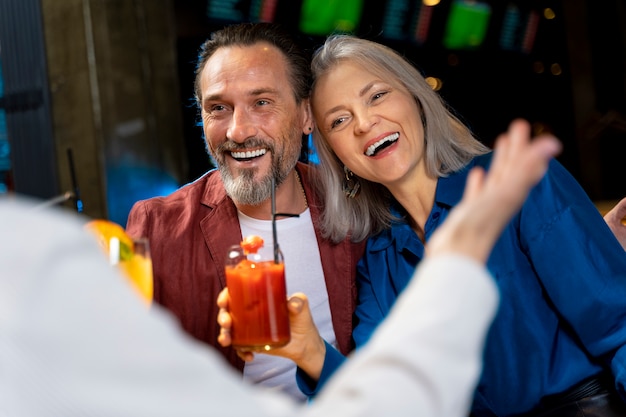 Drei ältere Freunde trinken und lachen in einem Restaurant
