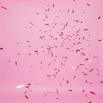 Dunkles konfetti, das auf rosa hintergrund fällt
