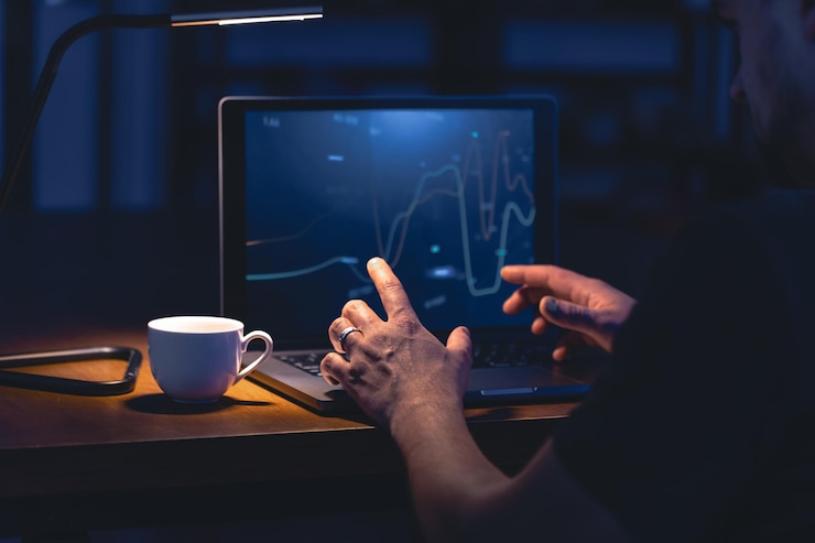 Kostenlose Foto ein mann, der nachts online-aktieninvestitionen durchsucht