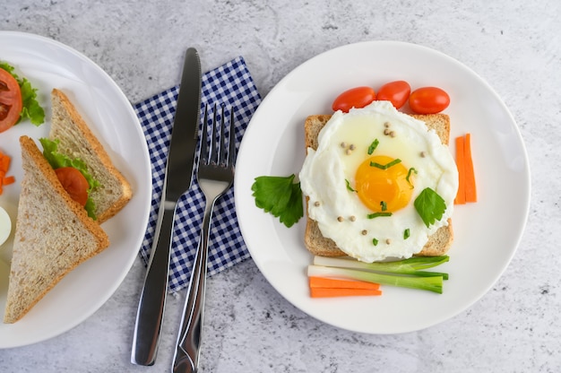 Ein Spiegelei, das auf einem Toast liegt und mit Pfeffersamen mit Karotten und Frühlingszwiebeln belegt ist.