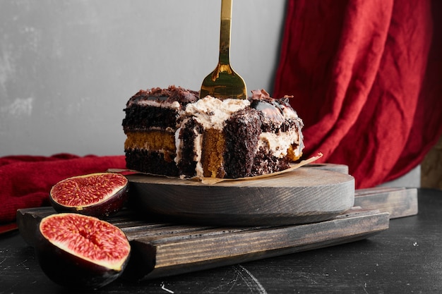 Ein Stück Schokoladenkäsekuchen auf einem Holzbrett.