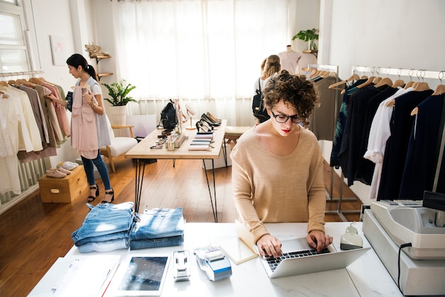 Ein weiblicher Geschäftseigentümer benutzt den Laptop