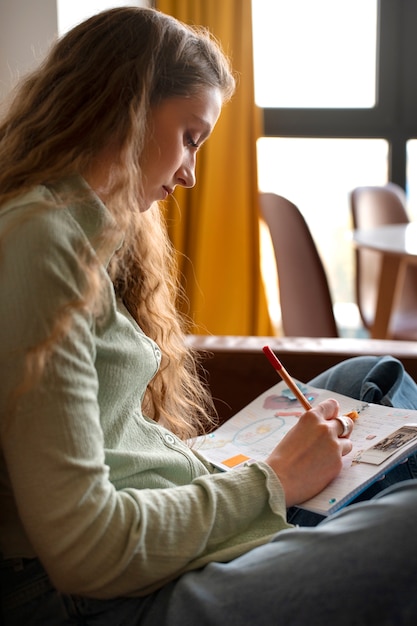 Eine Frau mit mittlerer Aufnahme macht kreatives Journaling