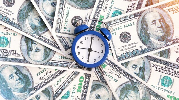 Eine Geldschicht mit der Uhr in der Mitte. Finanzidee