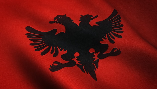 Eine realistische Aufnahme der schwingenden albanischen Flagge mit interessanten Texturen