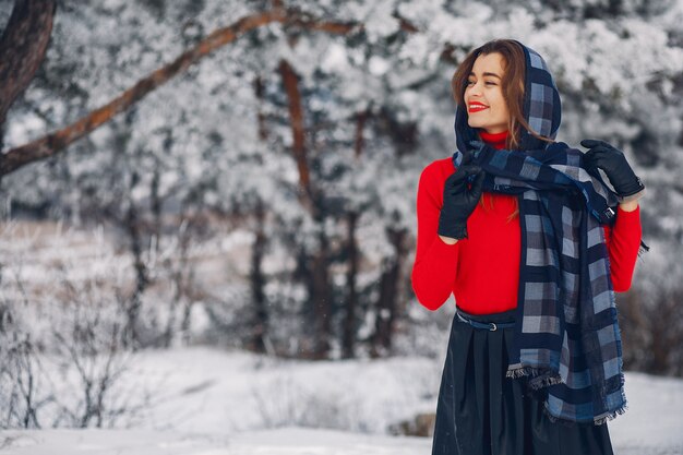 Elegantes und junges Mädchen in einem Winterpark