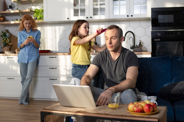 Eltern, die versuchen, von zu Hause aus zu arbeiten, umgeben von Kindern
