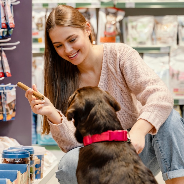 Entzückender Hund mit Besitzerin in der Tierhandlung