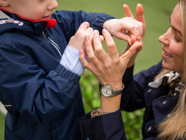 Entzückender Junge, der mit seiner Mutter spielt