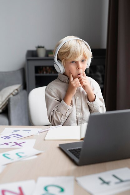 Entzückender kleiner Junge, der eine Online-Sitzung zur Sprachtherapie macht