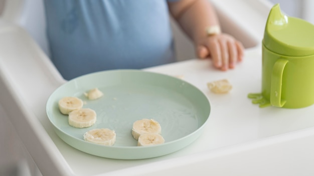 Entzückendes Baby, das mit Essen spielt