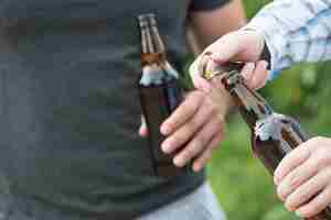 Kostenloses Foto ernte männer, die bier in der natur öffnen