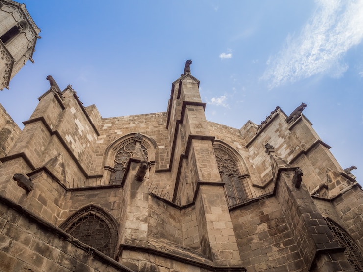 Kostenlose Foto erstaunliche ansicht des niedrigen winkels der kapelle von st. agatha und der römischen mauer in barcelona