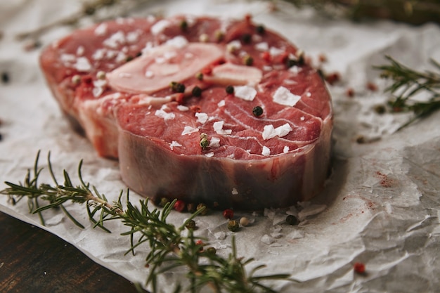 Essensset, Romero, rohes Fleischsteak, Salz, Pfeffer, Knoblauch, Olivenöl, Gabel