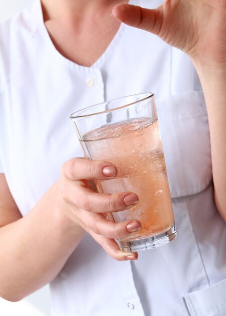 Fachmann. Kosmetikerin mit einem Glas Wasser