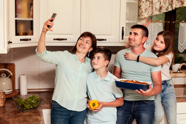 Familie, die Selfie in der Küche vor dem Abendessen nimmt