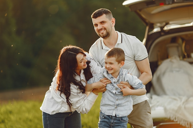 Familie in einem Sommerwald am offenen Stamm