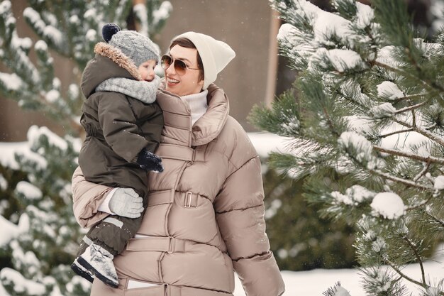 Familie in Winterkleidung im Urlaub im verschneiten Wald