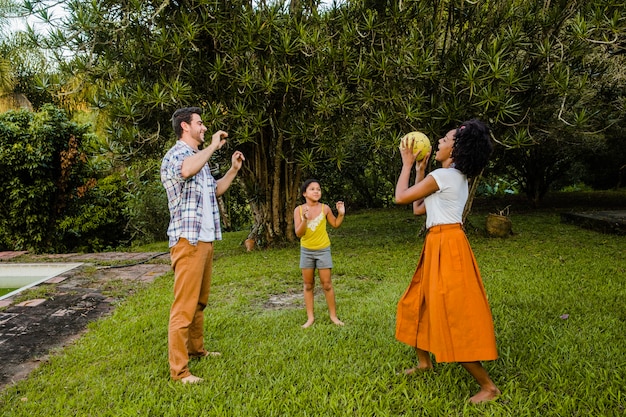 Familie spielt Ball im Garten