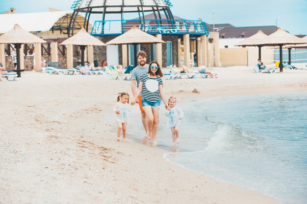 Familienurlaub Eltern und Kinder am Sommertag am Meer