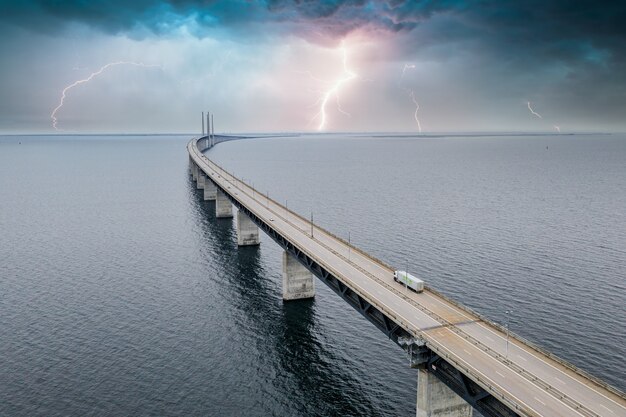 Faszinierende Luftaufnahme der Brücke zwischen Dänemark und Schweden unter freiem Himmel mit Blitz