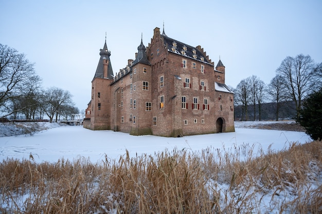 Faszinierender Sonnenaufgang über dem historischen Schloss Doorwerth im Winter in Holland