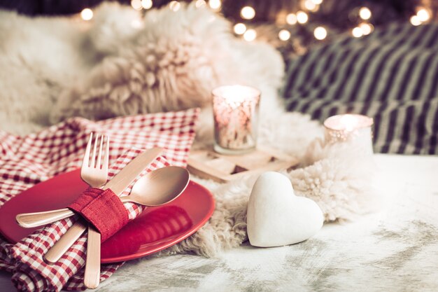 Festliches Abendessen zum Valentinstag auf einem hölzernen Hintergrundbesteck