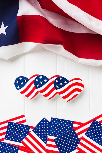 Kostenloses Foto flache lage von herzförmigen und regelmäßigen amerikanischen flaggen