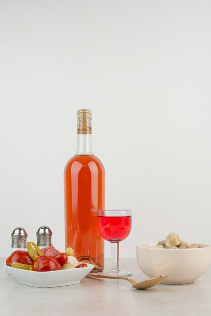 Flasche mit Glas Limonade und Knödelteller.