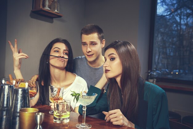 Foto von freudigen Freunden in der Bar oder in der Kneipe, die miteinander kommunizieren