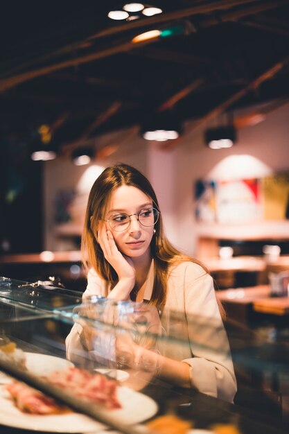 Frau, die am Cafézähler sitzt