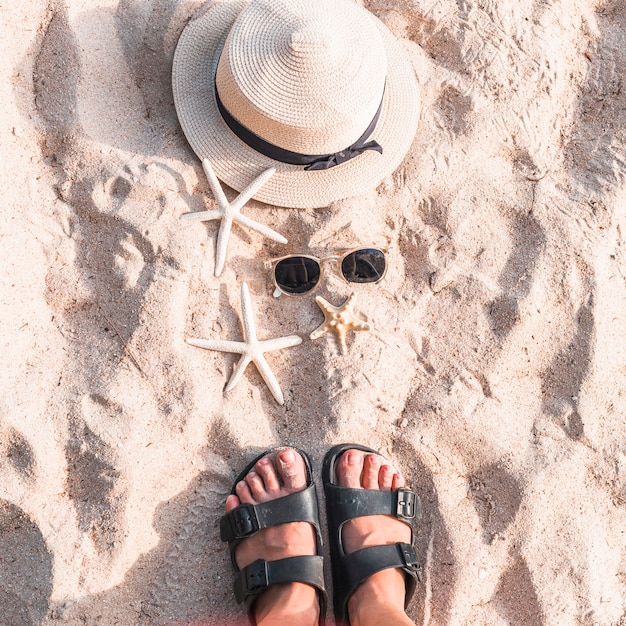 Frau, die auf Strandsand mit Starfishes steht