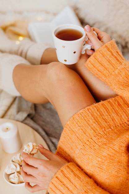 Frau, die die Winterferien mit einer Tasse Tee genießt