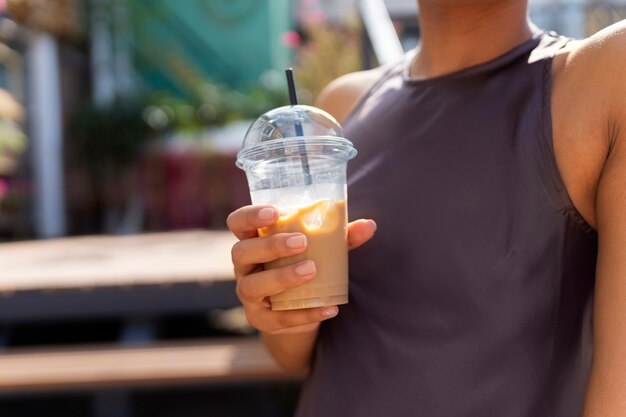 Frau, die draußen eine Eiskaffeepause hat