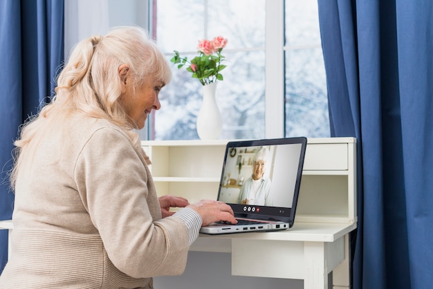 Frau, die drinnen einen Videoanruf tätigt