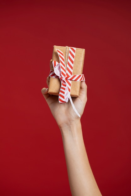 Kostenloses Foto frau, die ein eingewickeltes geschenk hält