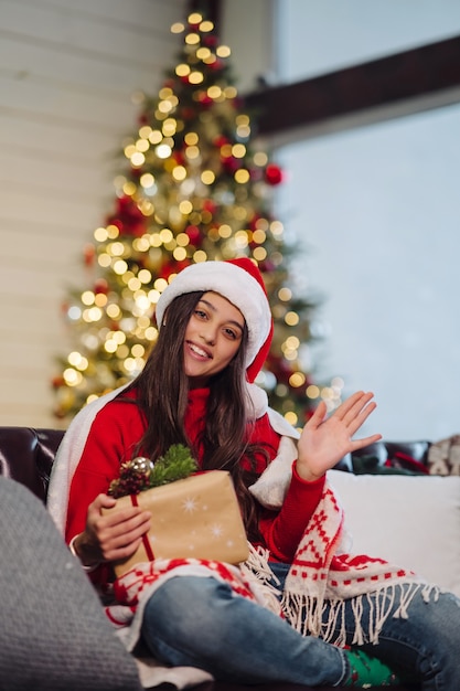 Frau, die ein Weihnachtsgeschenk in Weihnachten hält.